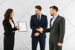 Portrait of young business people on grey background